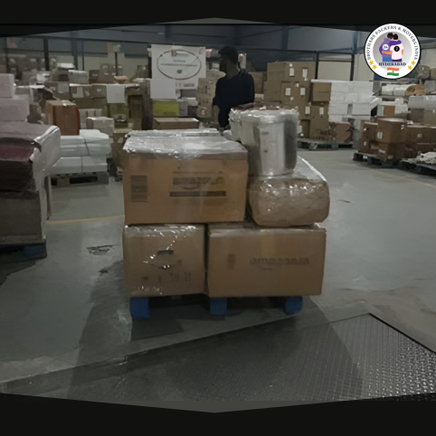 A man is standing in a warehouse around lots of boxes and various items